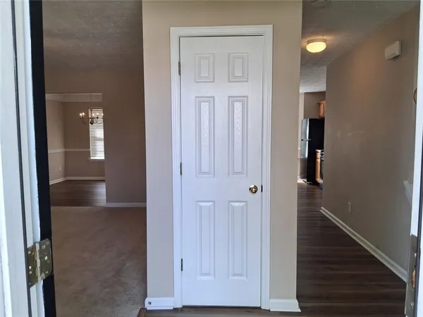 view of a hallway with wooden floor and staircase