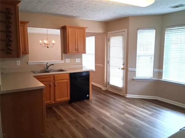 a kitchen with a sink and wooden cabinets