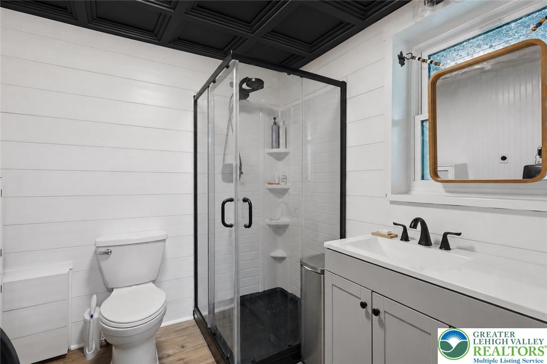 9033 Loop Road Slatington, PA 18080 - Photo 26 of 53 A well-appointed bathroom features a glass-enclosed shower, sleek vanity, and modern fixtures.