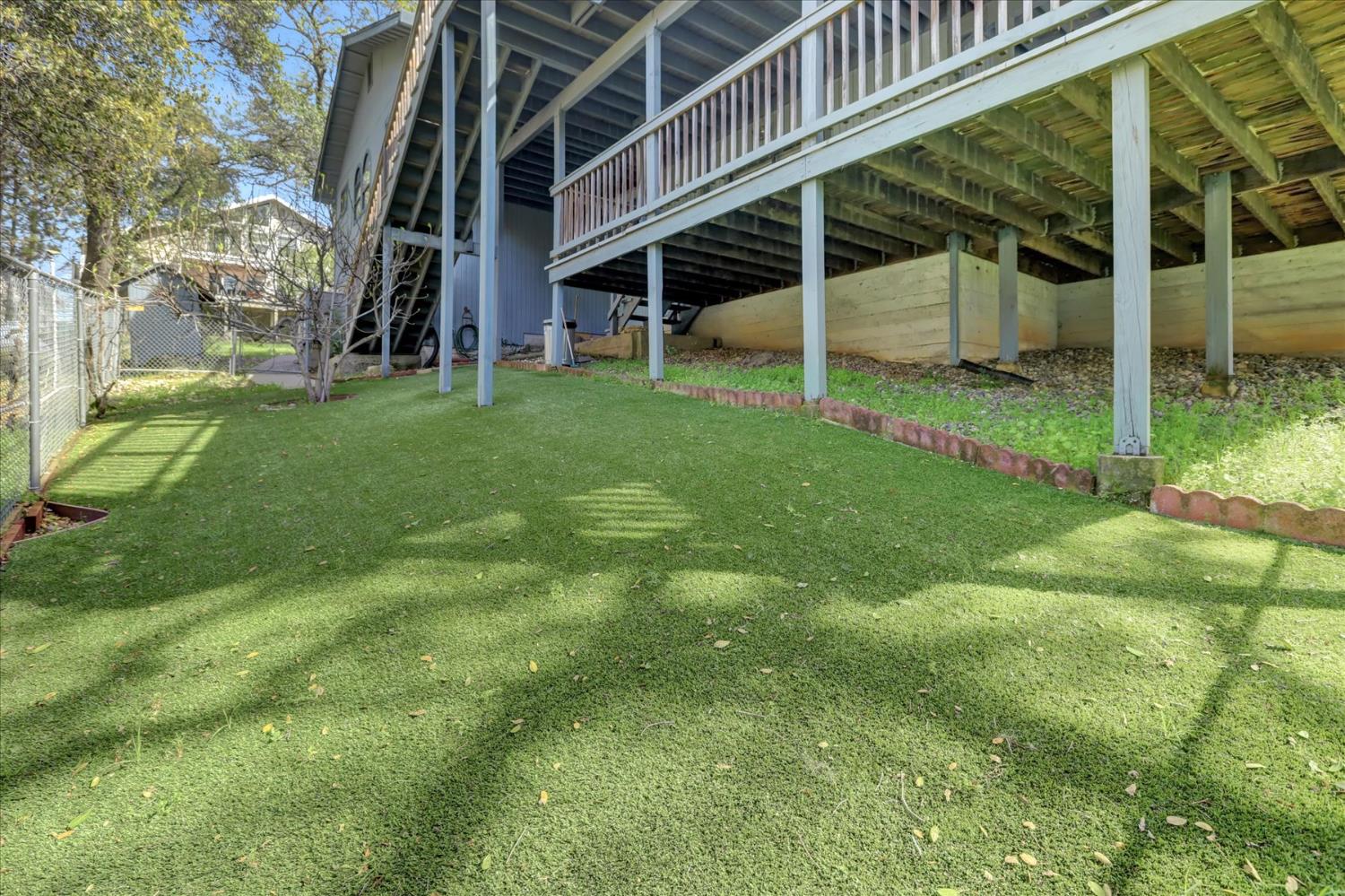 18167 Deer Run Penn Valley, CA 95946 - Photo 65 of 92 Dog run with artificial turf.. stays clean, no dirt to track in your home!