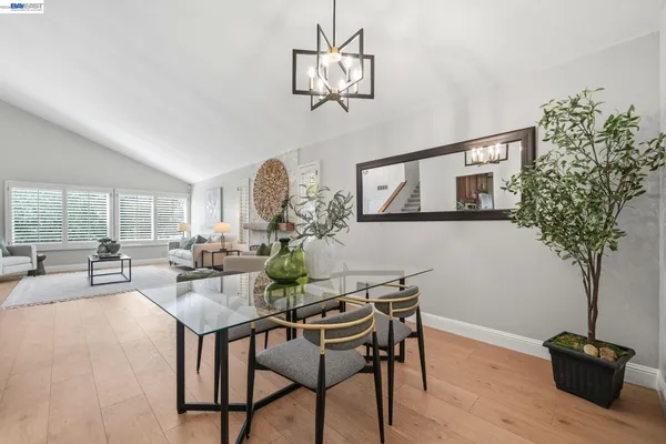 a bedroom with a bed and painting on the wall