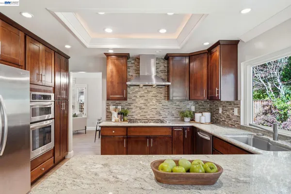 an aerial view of a house with a yard and furniture