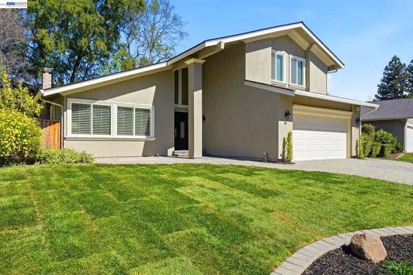 a front view of a house with a garden