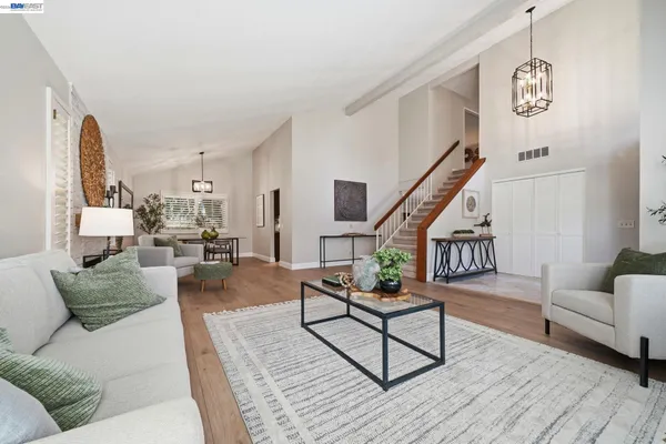 a kitchen with kitchen island granite countertop a sink stainless steel appliances and cabinets