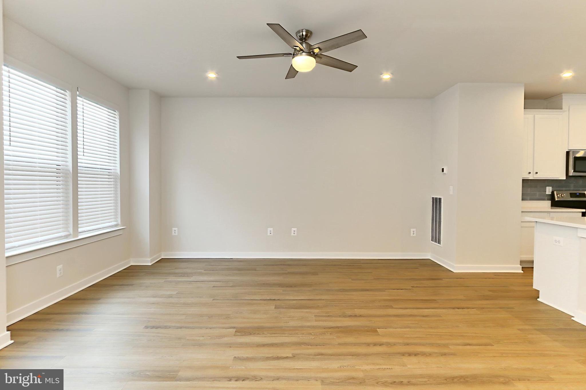 14176 Gypsum Loop Chantilly, VA 20151 - Photo 12 of 43 a view of an empty room with window and wooden floor