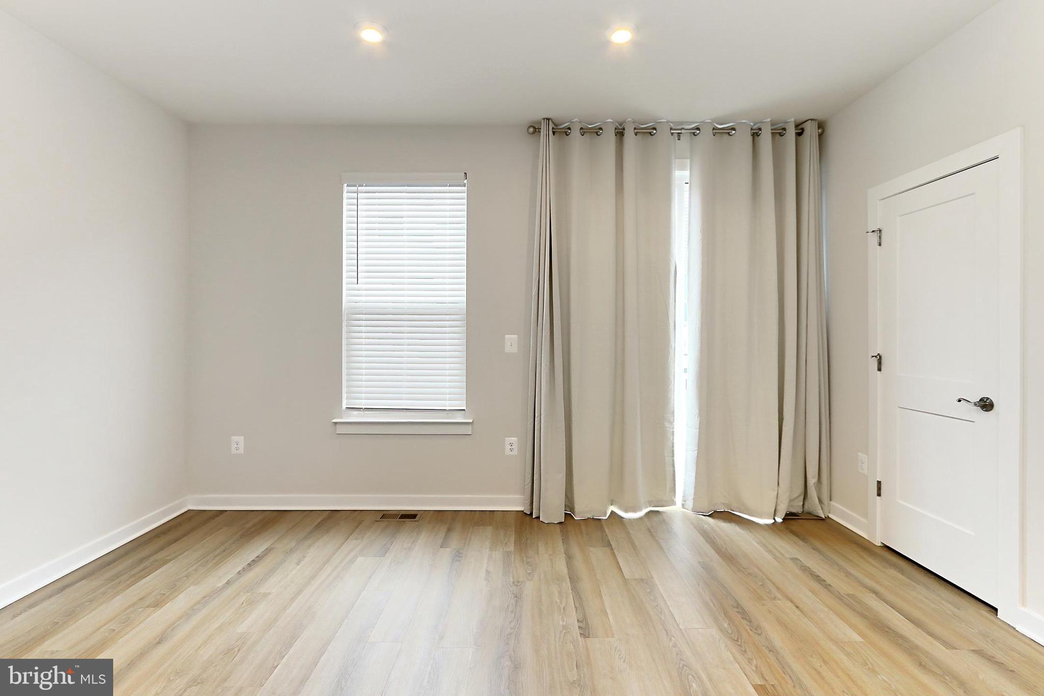 14176 Gypsum Loop Chantilly, VA 20151 - Photo 14 of 43 an empty room with wooden floor and windows