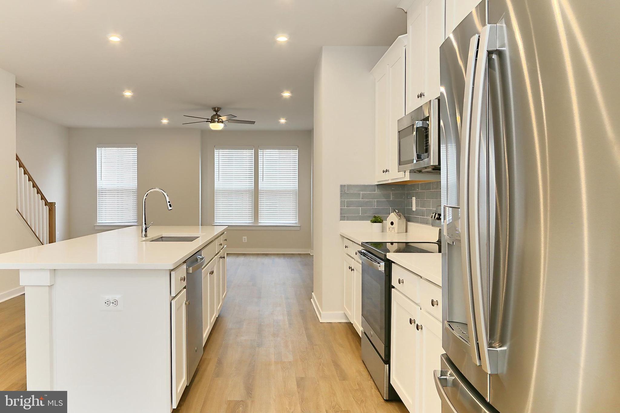 14176 Gypsum Loop Chantilly, VA 20151 - Photo 18 of 43 a kitchen with stainless steel appliances granite countertop a sink and cabinets