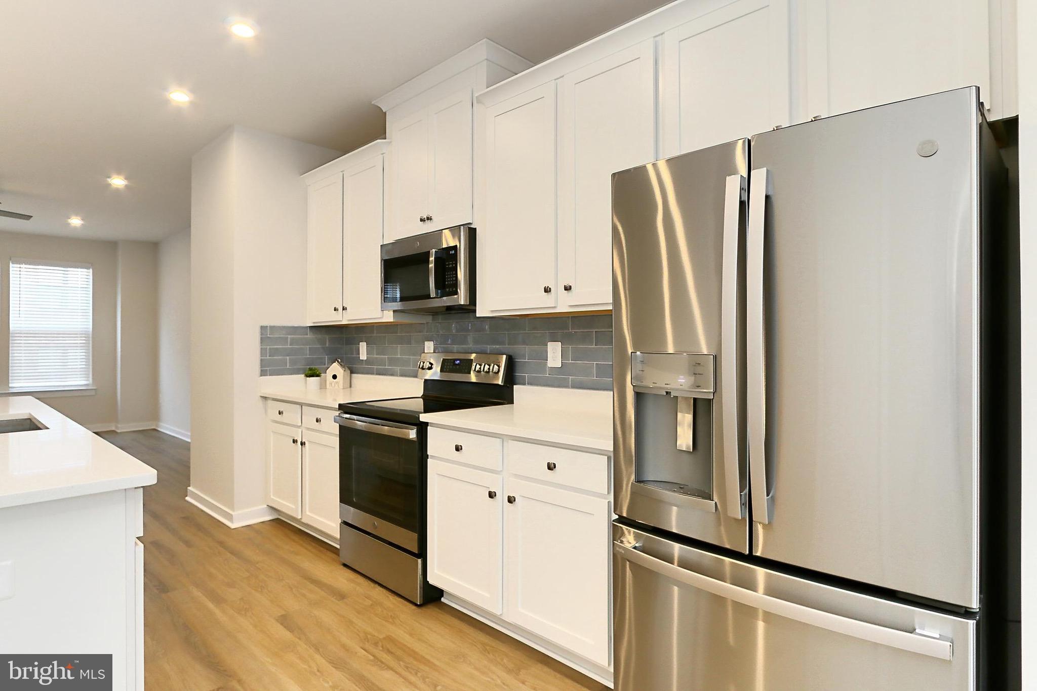 14176 Gypsum Loop Chantilly, VA 20151 - Photo 19 of 43 a kitchen with stainless steel appliances a refrigerator sink and microwave