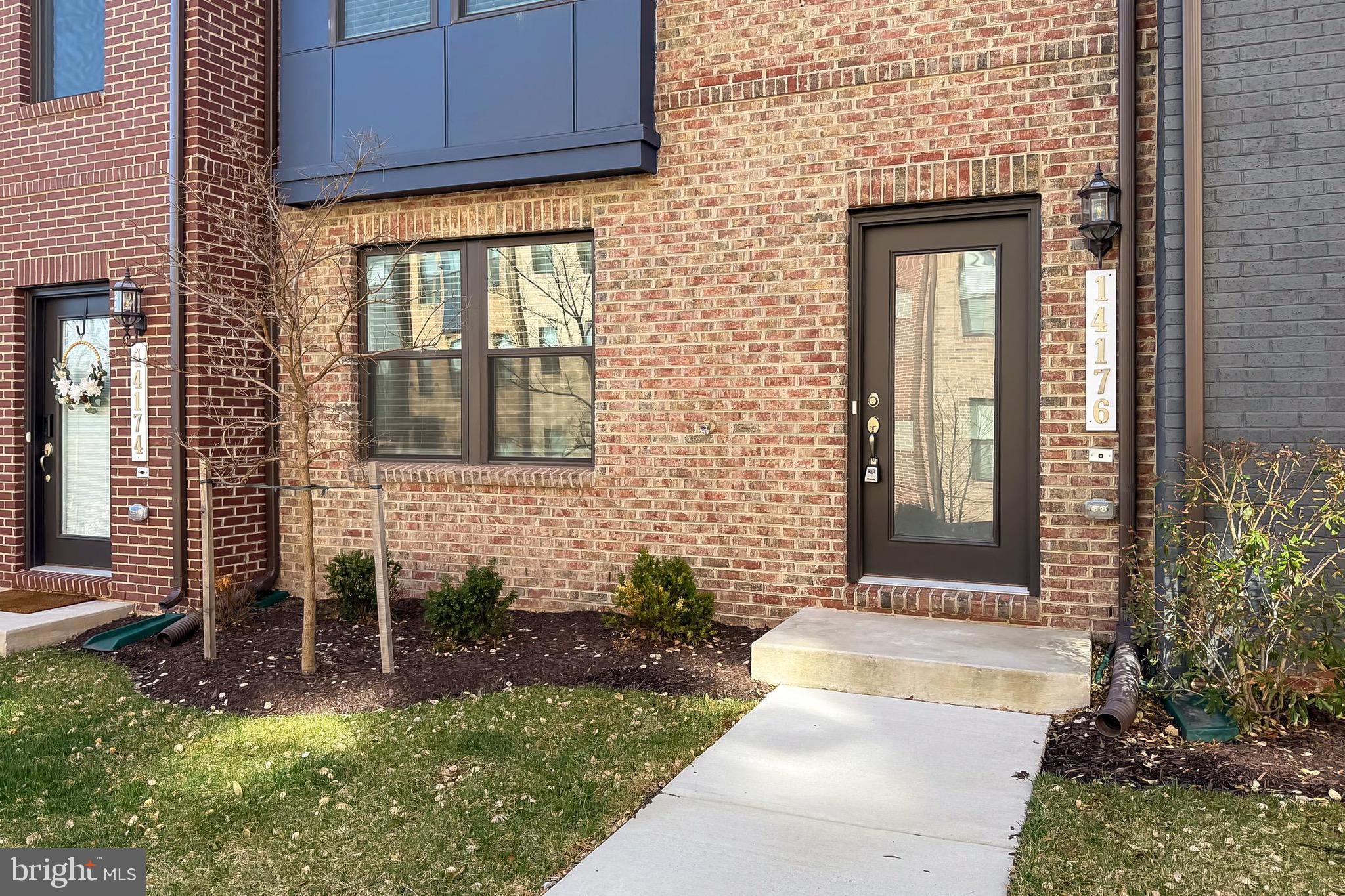 14176 Gypsum Loop Chantilly, VA 20151 - Photo 3 of 43 a front view of a house with a yard