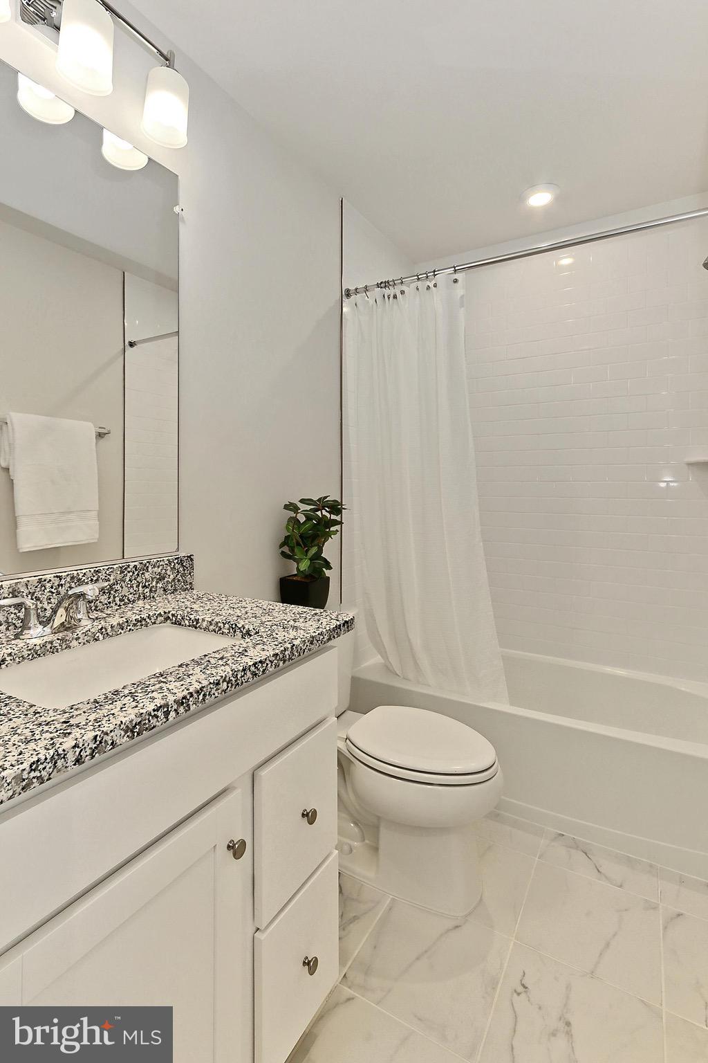 14176 Gypsum Loop Chantilly, VA 20151 - Photo 40 of 43 a bathroom with a granite countertop sink toilet and shower