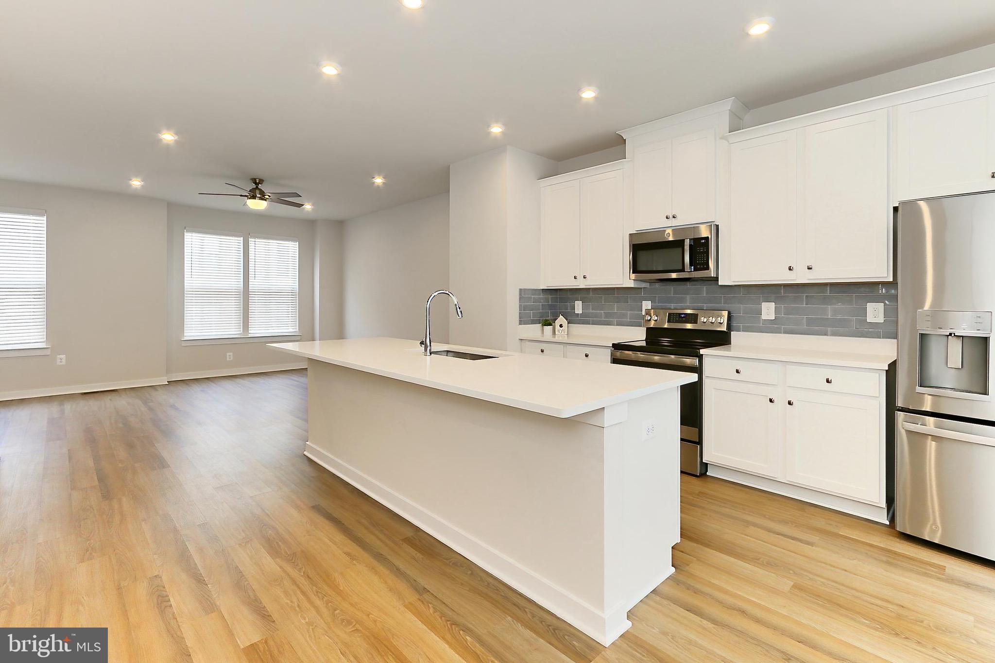 14176 Gypsum Loop Chantilly, VA 20151 - Photo 6 of 43 a kitchen with stainless steel appliances a refrigerator sink and microwave