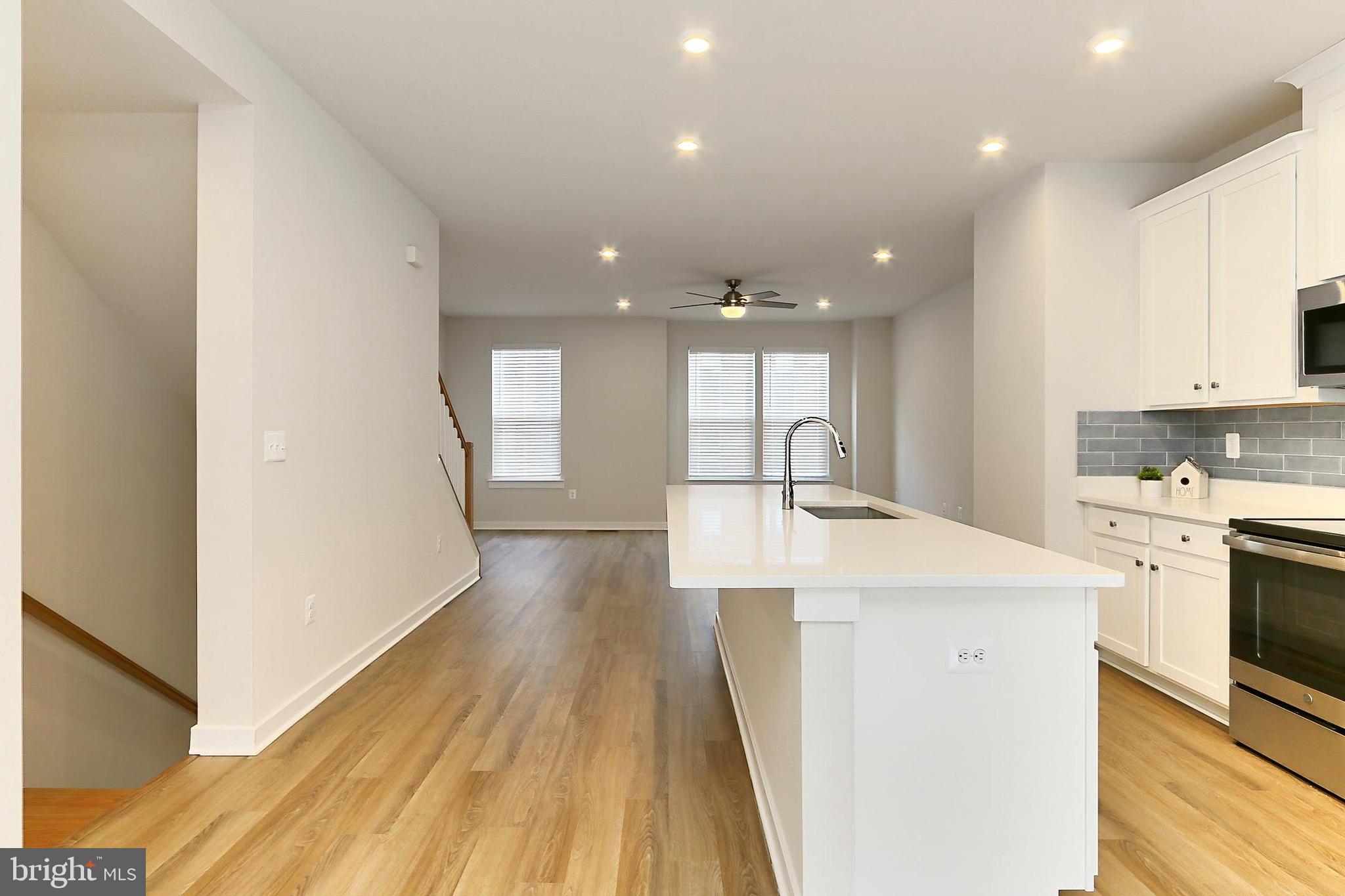 14176 Gypsum Loop Chantilly, VA 20151 - Photo 7 of 43 a kitchen with a sink and wooden floor