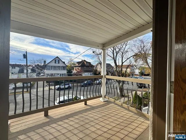 a view of a balcony with wooden floor