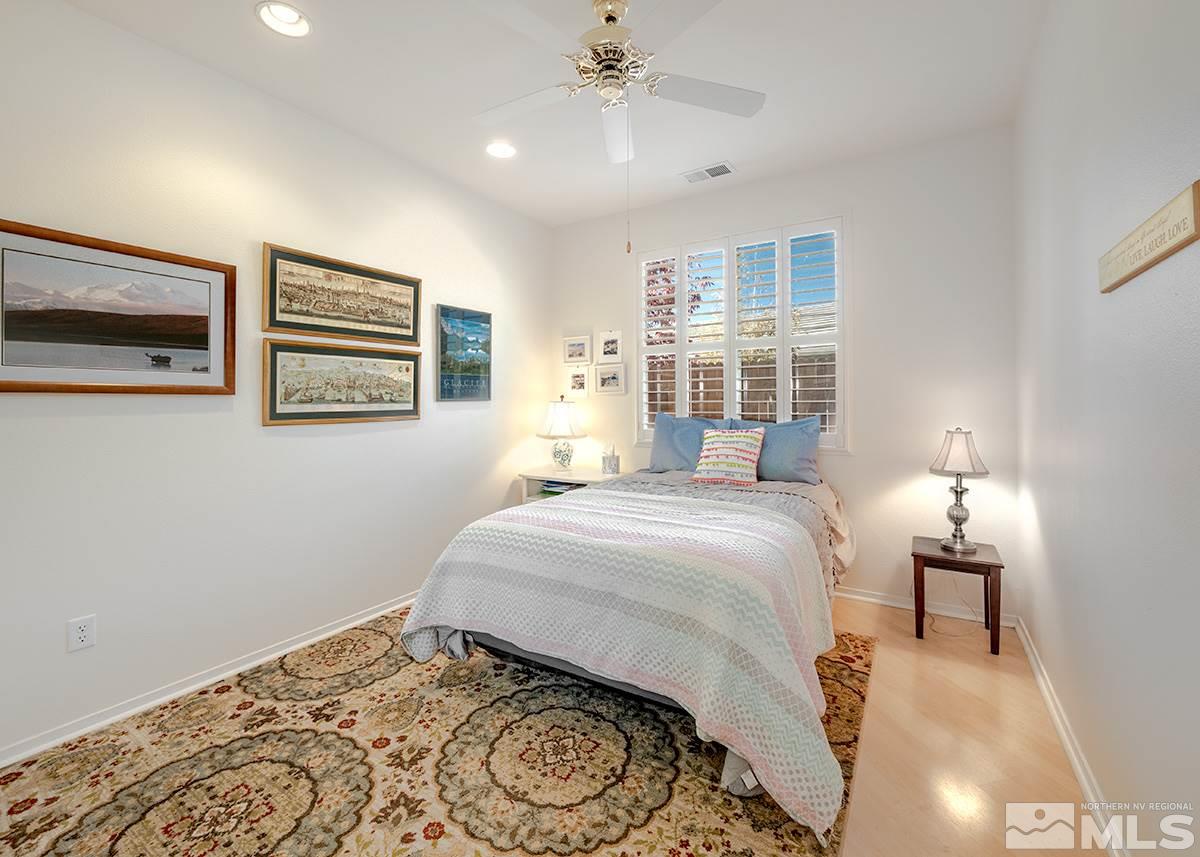 1408 Wild Wolf Way Reno, NV 89521 - Photo 12 of 24 a bedroom with a bed and a chandelier