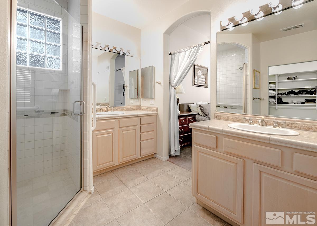 1408 Wild Wolf Way Reno, NV 89521 - Photo 17 of 24 a spacious bathroom with a granite countertop sink mirror and a