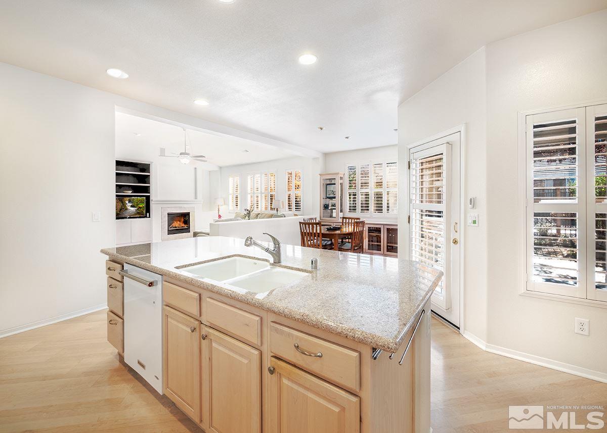 1408 Wild Wolf Way Reno, NV 89521 - Photo 8 of 24 a kitchen with center island and stainless steel appliances