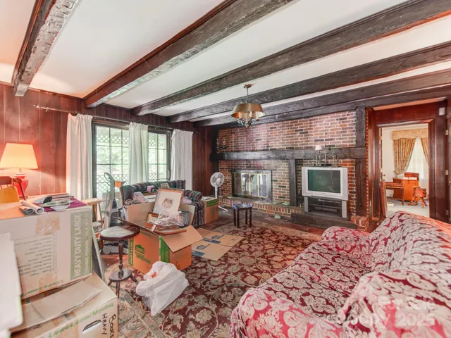 a living room with furniture a rug and a large window