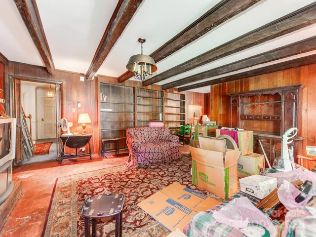 a kitchen with stainless steel appliances granite countertop a refrigerator a sink dishwasher a dining table and chairs with wooden floor