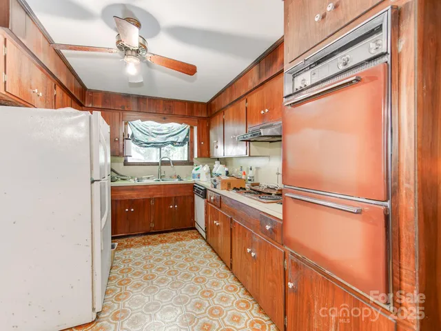 a kitchen with a sink a stove and cabinets