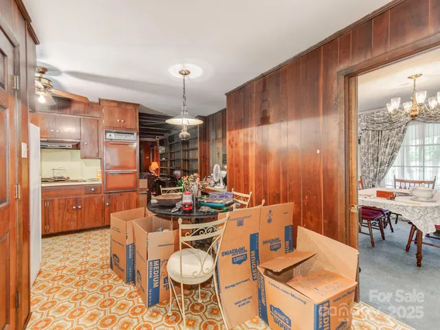 a kitchen with a sink a stove cabinets and wooden floor
