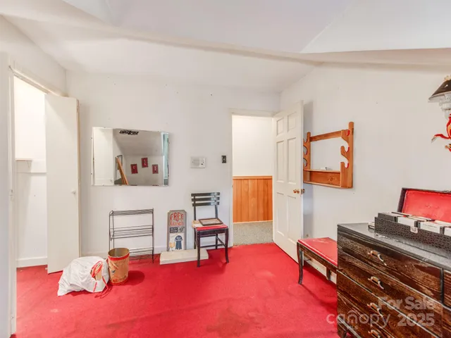 a living room with furniture a rug and a window