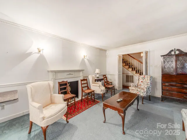 a view of a dining room with furniture and a chandelier