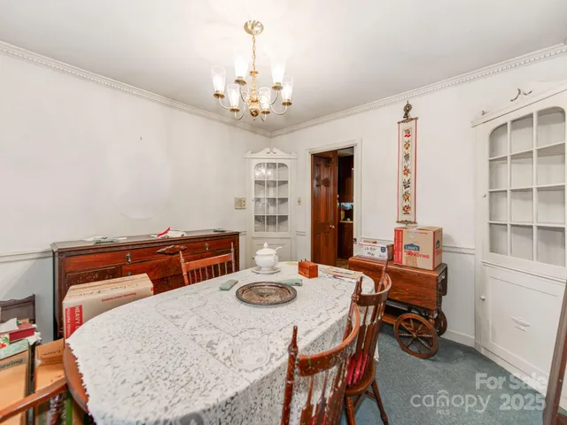 a dining room with furniture and a chandelier