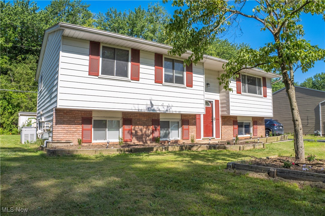 1770 Meadows Road Madison, OH 44057 - Photo 2 of 22 Bi-level home with brick siding and a front yard