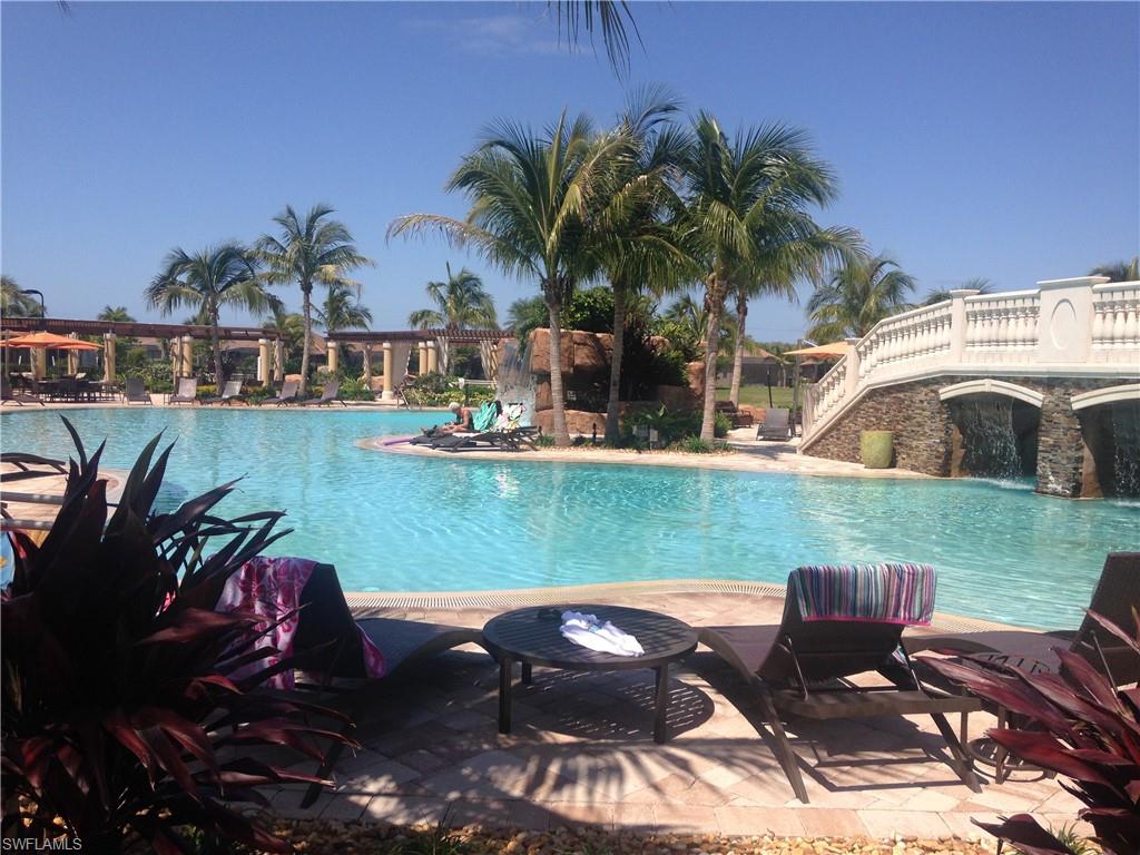 a view of a swimming pool and lounge chairs
