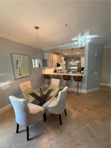 a living room with a couch and chandelier
