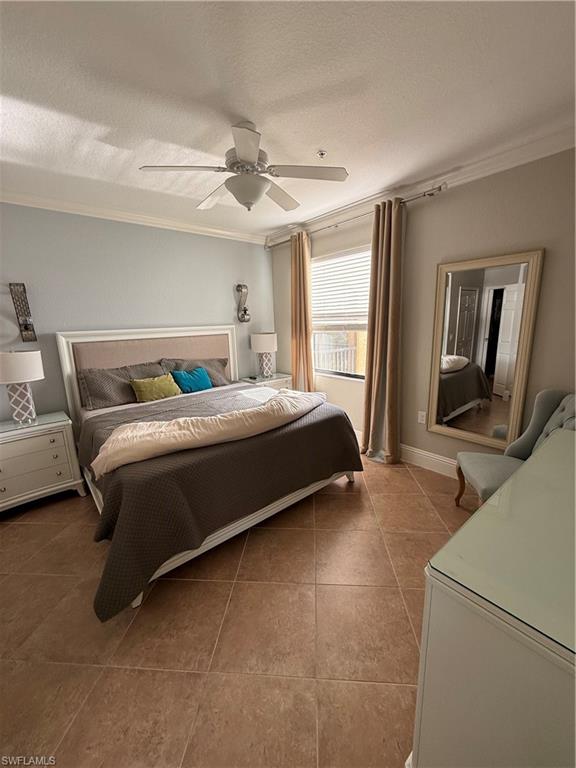 9719 Acqua Court, Unit 238 Naples, FL 34113 - Photo 19 of 25 a bedroom with a bed couch and a window
