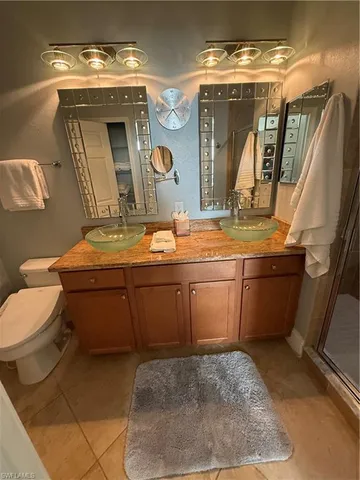 a bathroom with a sink mirror vanity and toilet