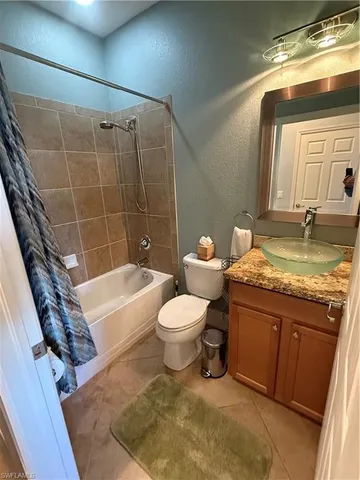 a bathroom with a sink a toilet and bathtub