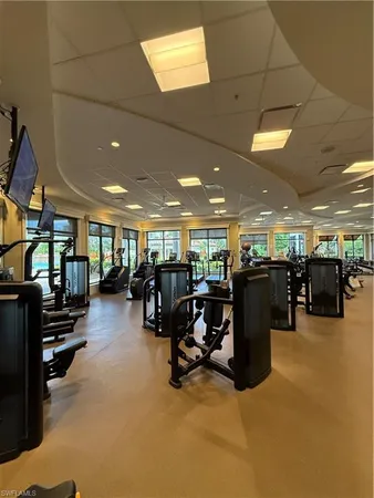a view of a room with gym equipment and a large window