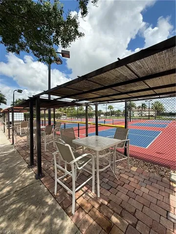 an outdoor sitting area with a table and chairs