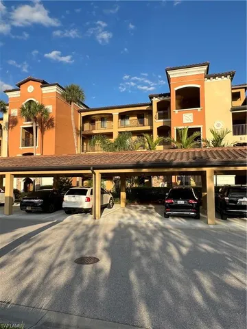 a view of building with car parked