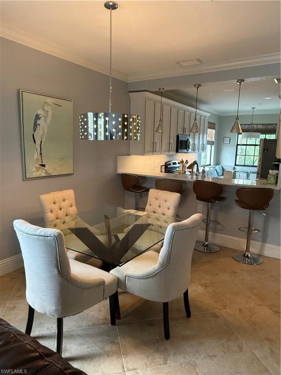 9719 Acqua Court, Unit 238 Naples, FL 34113 - Photo 10 of 25 a view of a dining room with furniture window and wooden floor