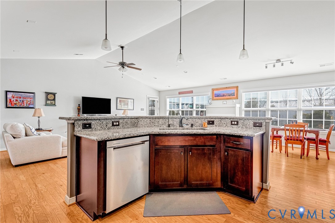 7401 Leaf Fall Way Mechanicsville, VA 23111 - Photo 16 of 48 a kitchen with stainless steel appliances granite countertop a stove and a view of living room