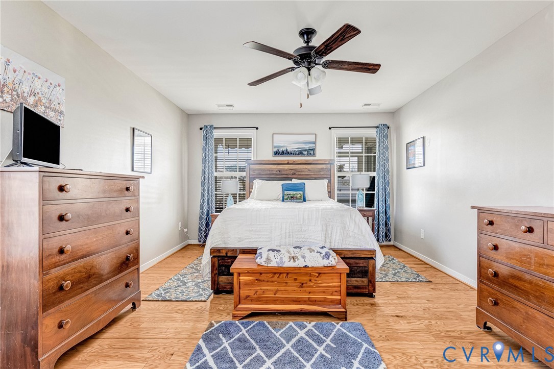7401 Leaf Fall Way Mechanicsville, VA 23111 - Photo 18 of 48 a bedroom with a bed and wooden floor