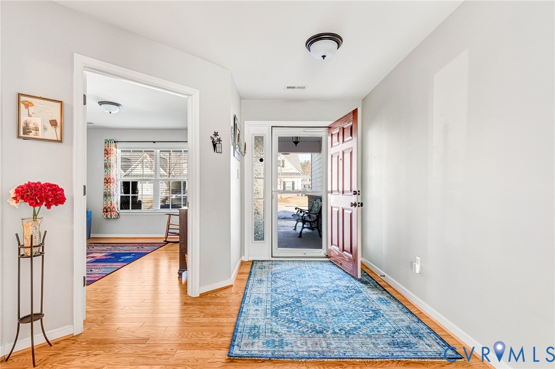 7401 Leaf Fall Way Mechanicsville, VA 23111 - Photo 4 of 48 a view of a hallway view with wooden floor and a rug