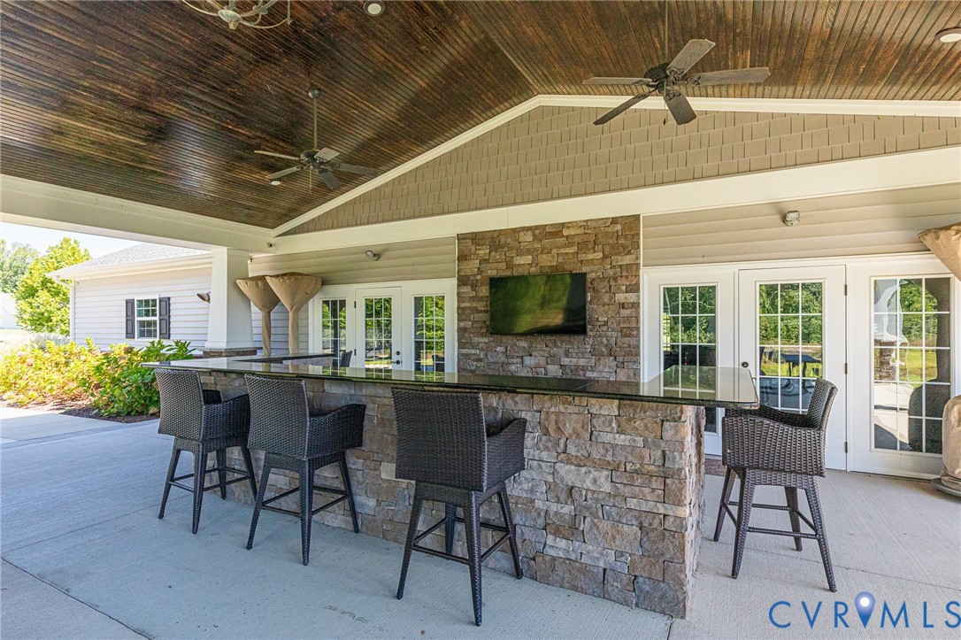 7401 Leaf Fall Way Mechanicsville, VA 23111 - Photo 44 of 48 a dining room with furniture a floor to ceiling window and potted plants