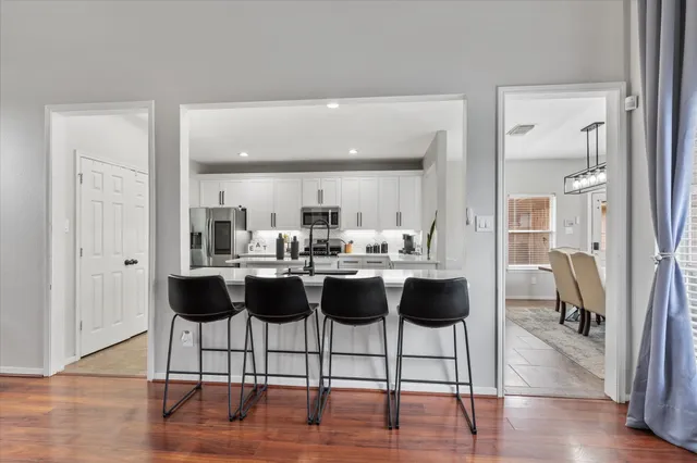 a view of living room with furniture and wooden floor