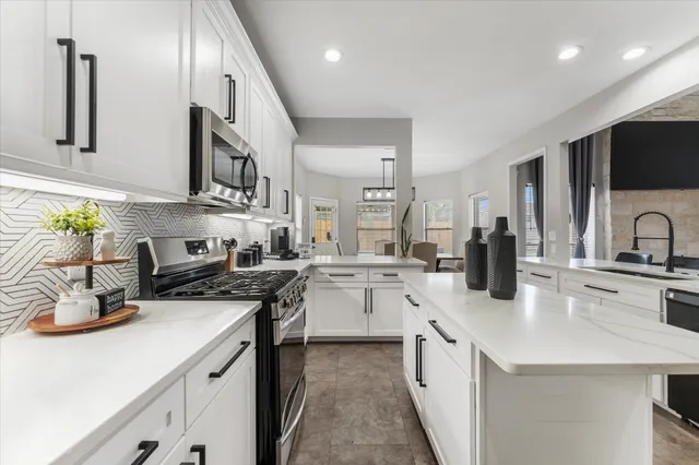 a kitchen with a sink stove and cabinets