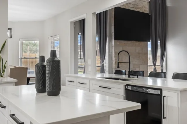 a kitchen with granite countertop a stove and a refrigerator