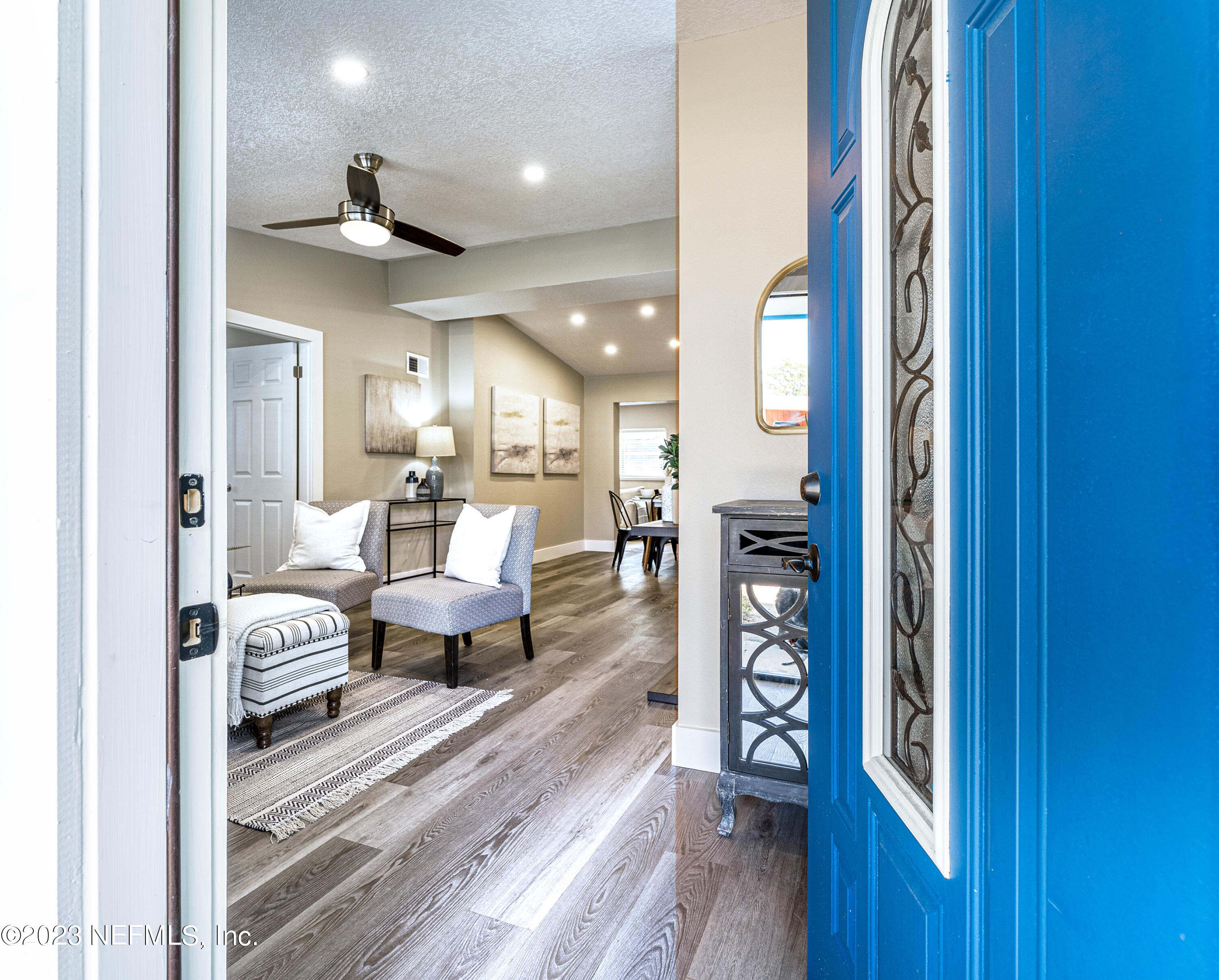 a living room with furniture and a wooden floor
