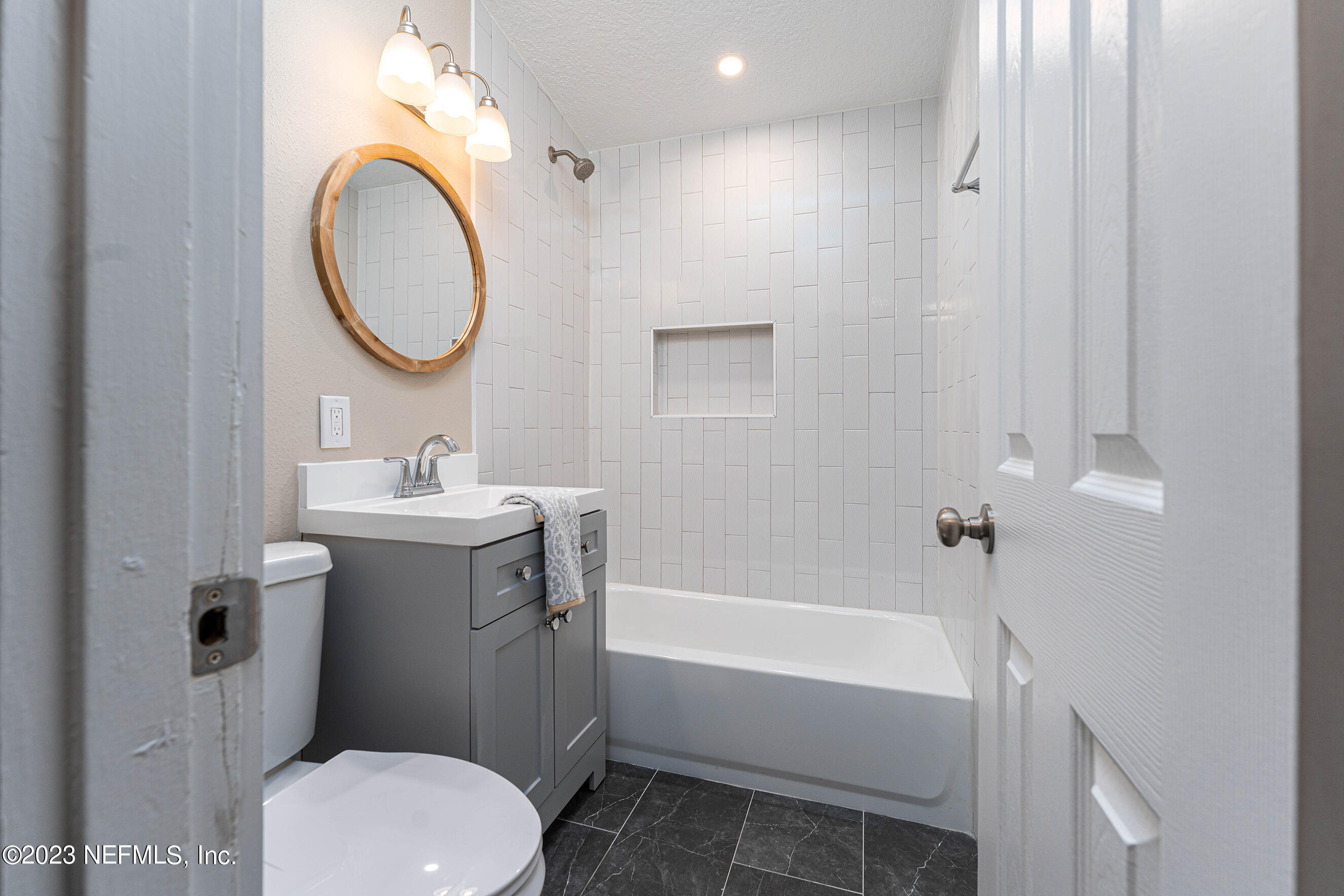 939 Westgate Drive Jacksonville, FL 32221 - Photo 14 of 31 a bathroom with a sink a toilet and a mirror