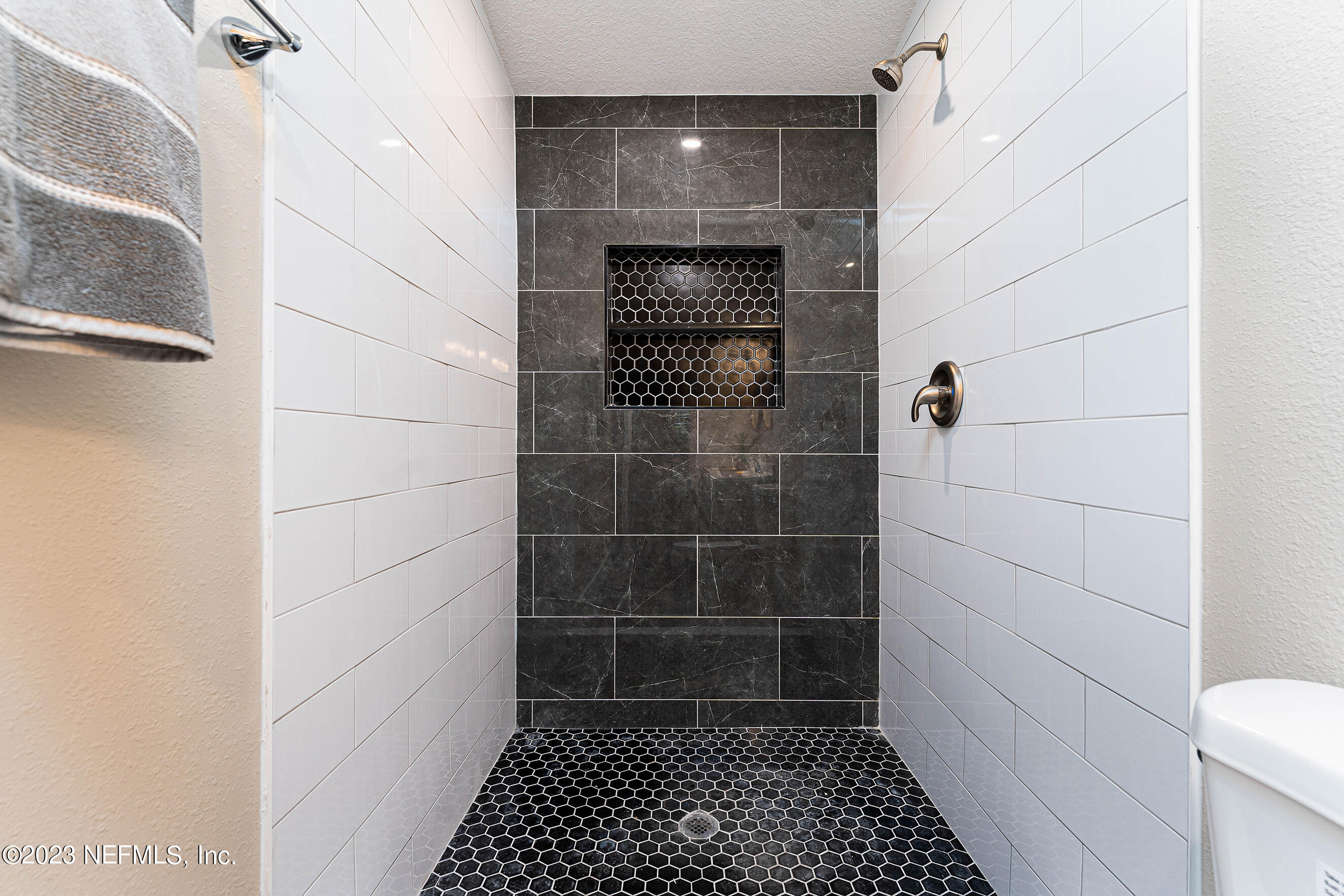 939 Westgate Drive Jacksonville, FL 32221 - Photo 16 of 31 a bathroom with a toilet and a shower