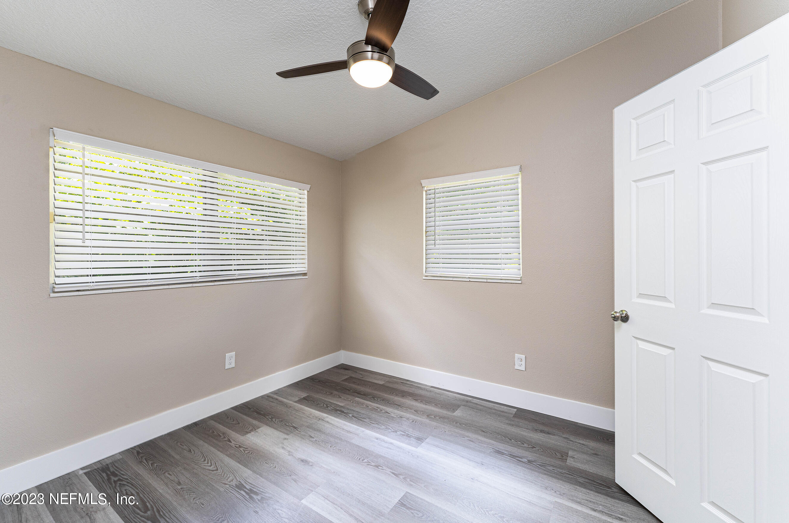 939 Westgate Drive Jacksonville, FL 32221 - Photo 20 of 31 a view of empty room with wooden floor and fan