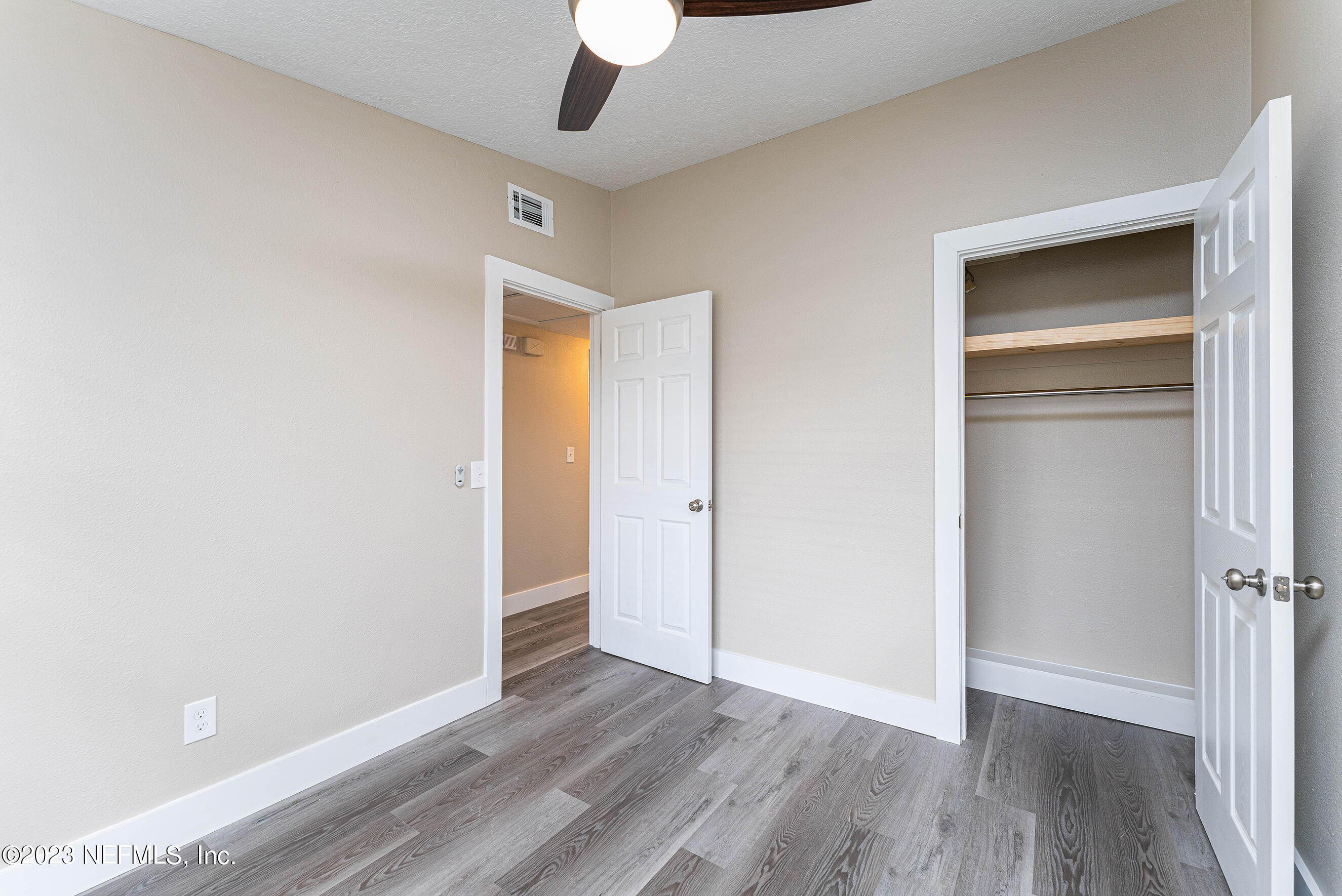 939 Westgate Drive Jacksonville, FL 32221 - Photo 23 of 31 an empty room with wooden floor closet and windows