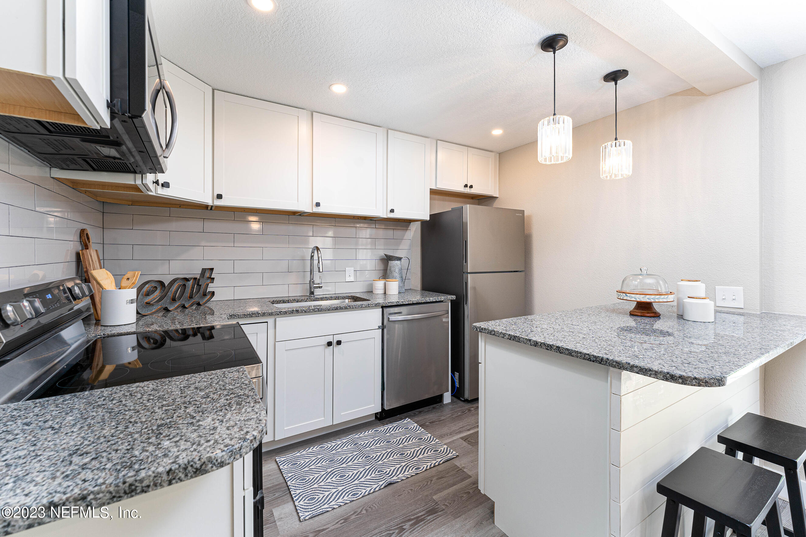 939 Westgate Drive Jacksonville, FL 32221 - Photo 8 of 31 a kitchen with a sink a stove a refrigerator and cabinets